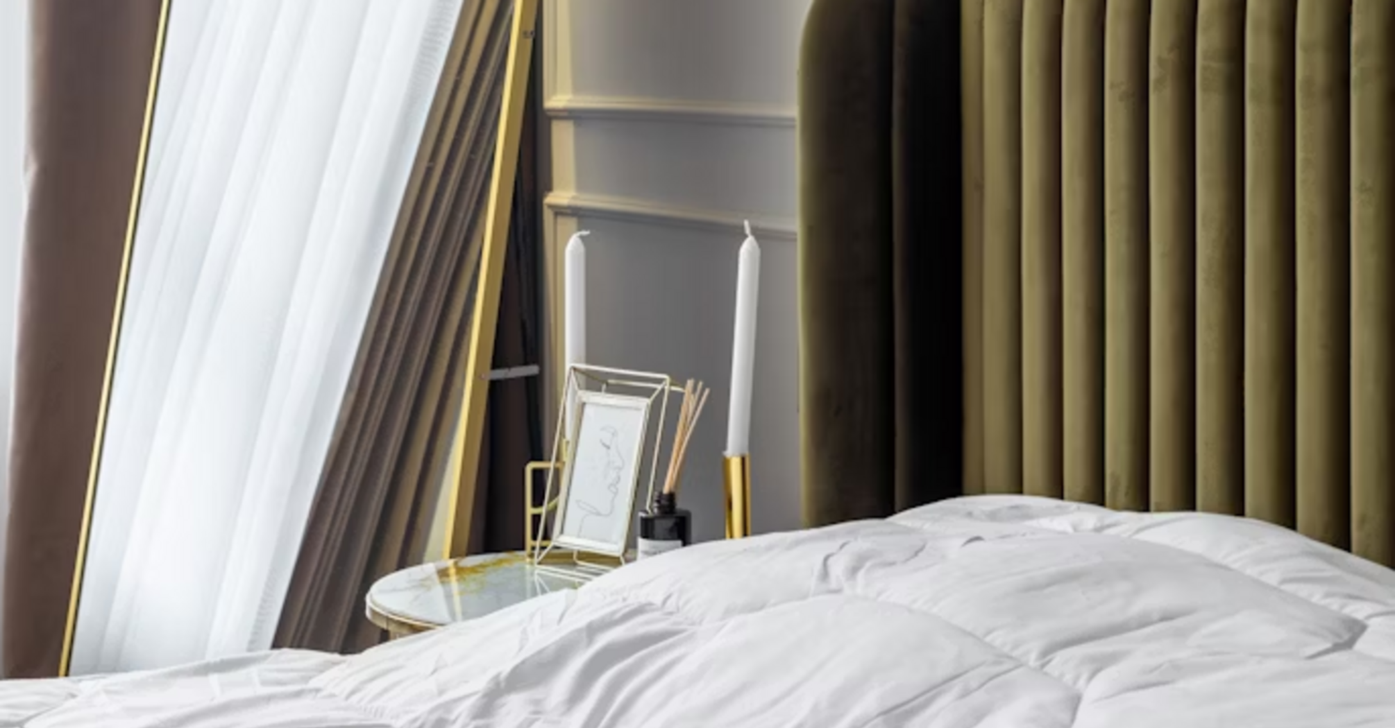 Modern hotel bedroom with stylish mirror and soft lighting