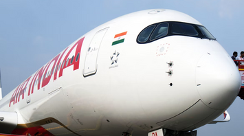 Air India aircraft on the runway with the Indian flag visible near the cockpit