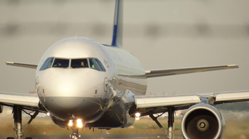 Front view of a Lufthansa aircraft taxiing on runway