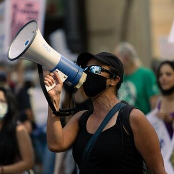 Protester with a megaphone during a public demonstration in Italy