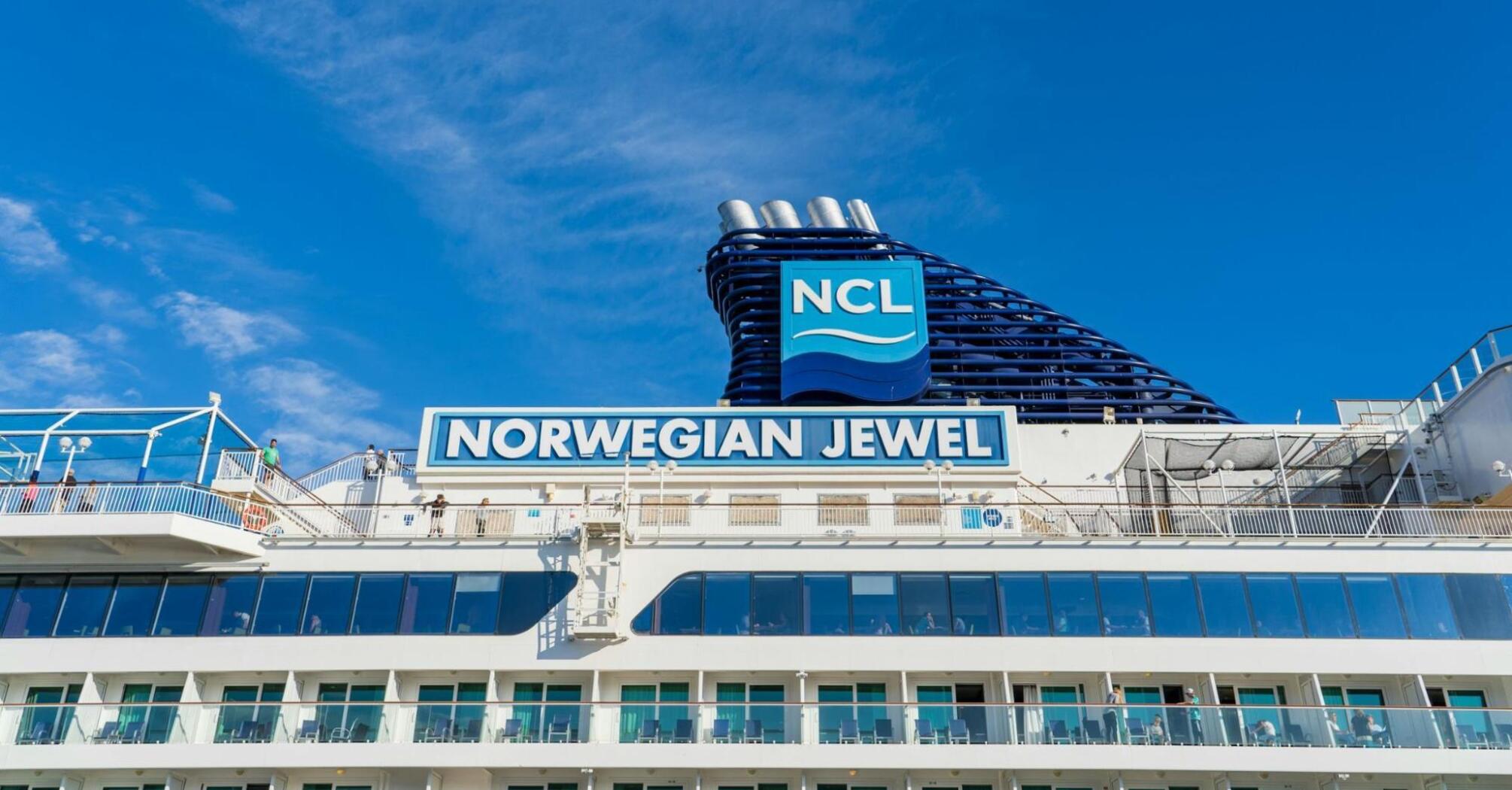 Norwegian Cruise Line ship under clear blue sky at port