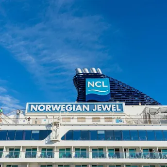 Norwegian Cruise Line ship under clear blue sky at port