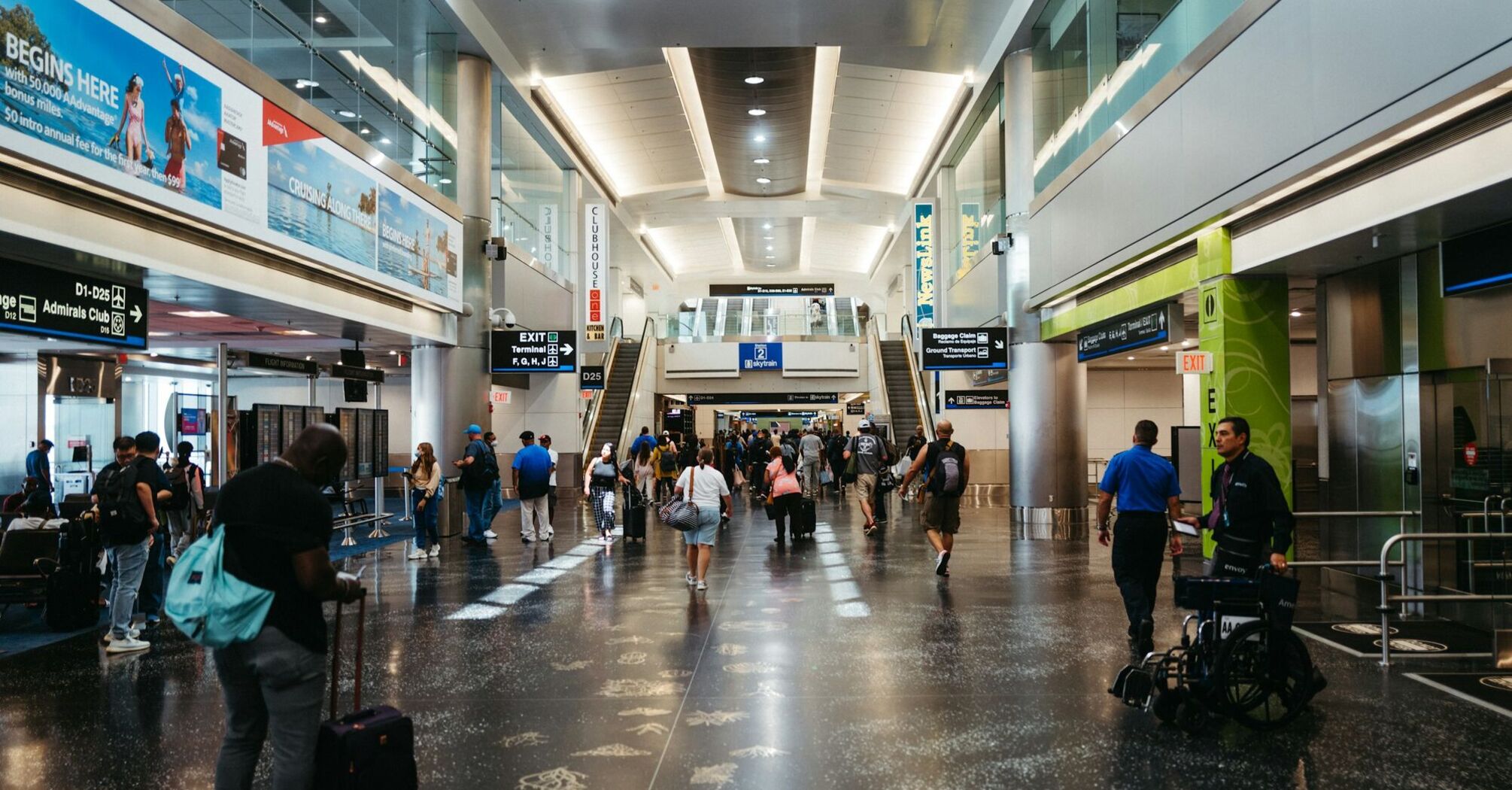 Passengers walking through a busy airport terminal in the United States
