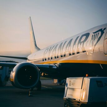 Ryanair aircraft preparing for boarding at the airport during sunrise