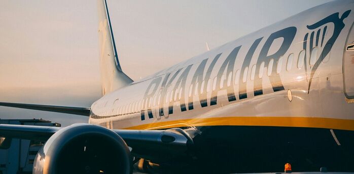 Ryanair aircraft preparing for boarding at the airport during sunrise