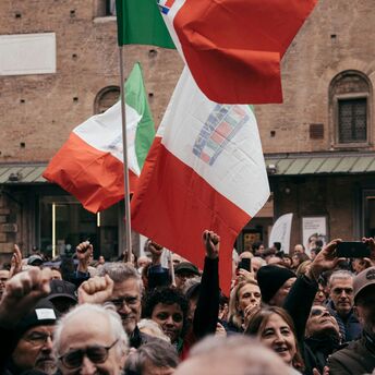 Crowd holding Italian flags during a public protest