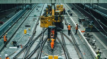 Railway maintenance workers repairing train tracks in northern Italy