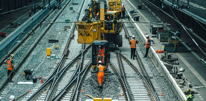 Railway maintenance workers repairing train tracks in northern Italy