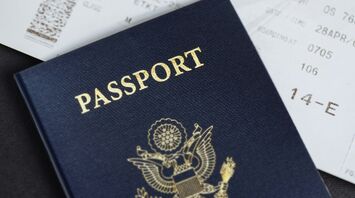Close-up of a passport placed on top of a boarding pass
