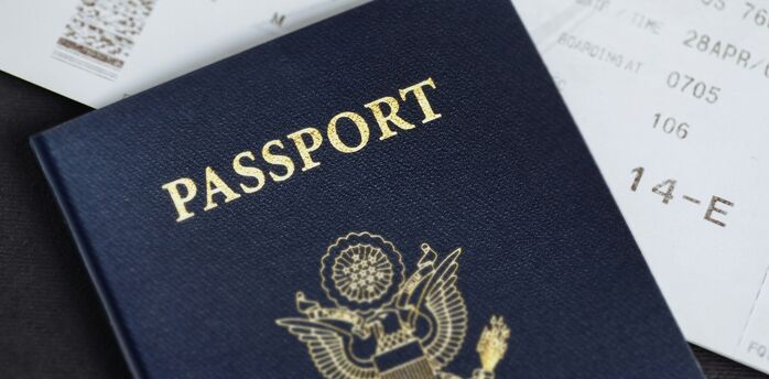 Close-up of a passport placed on top of a boarding pass