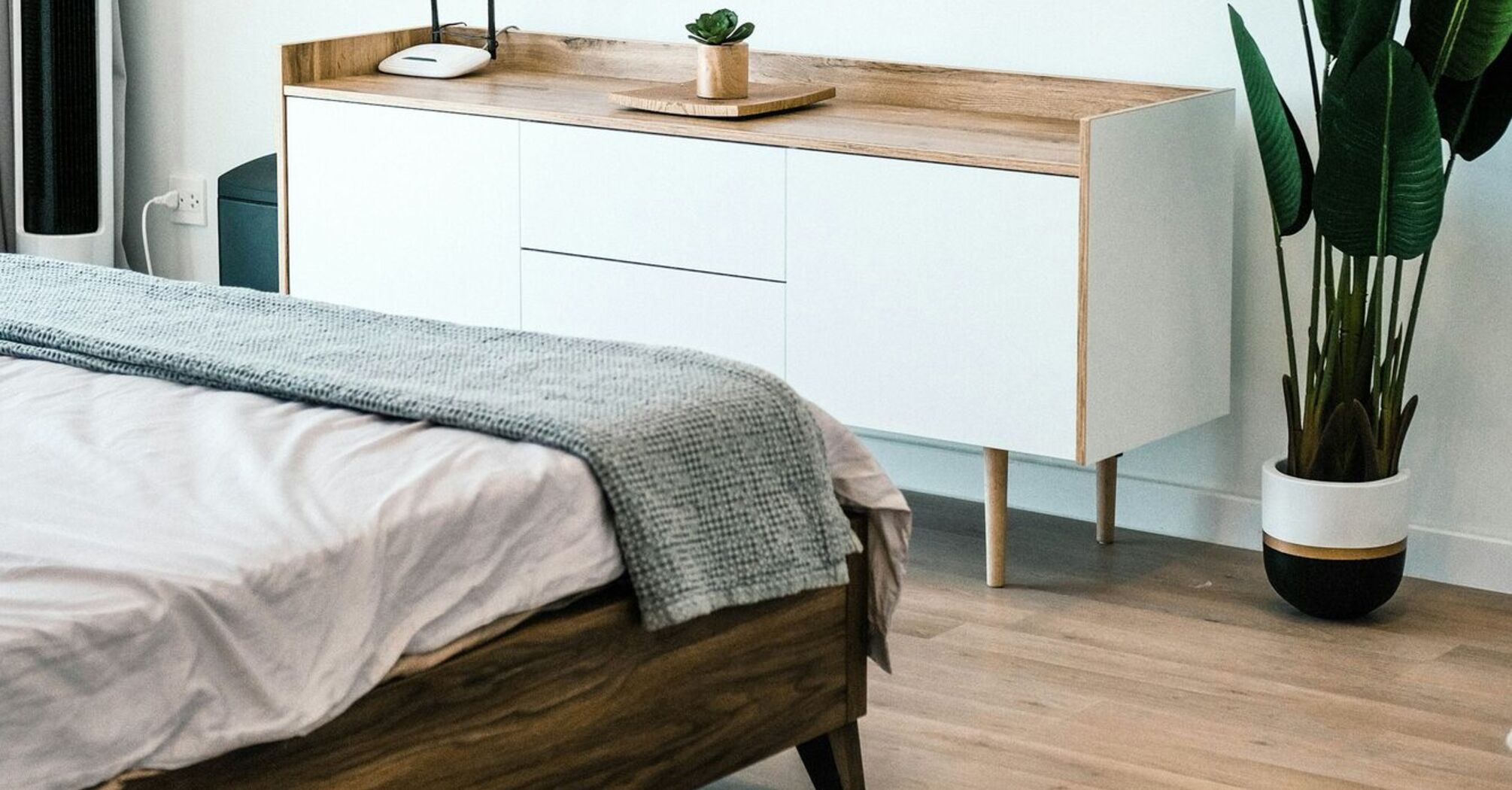 Minimalist hotel-style bedroom interior with natural wood accents