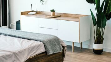 Minimalist hotel-style bedroom interior with natural wood accents