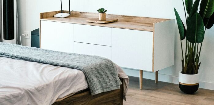 Minimalist hotel-style bedroom interior with natural wood accents