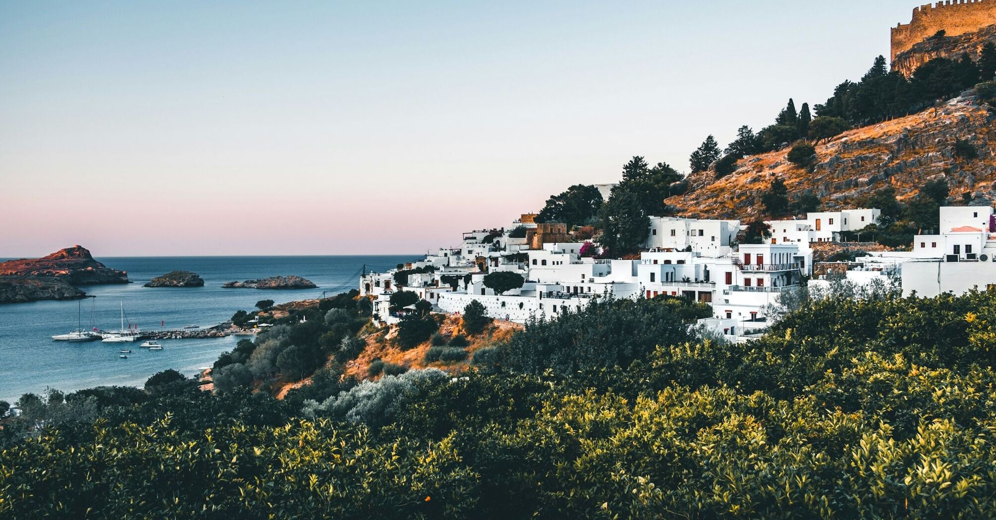 Greek hillside village overlooking a calm bay