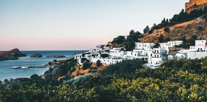 Greek hillside village overlooking a calm bay