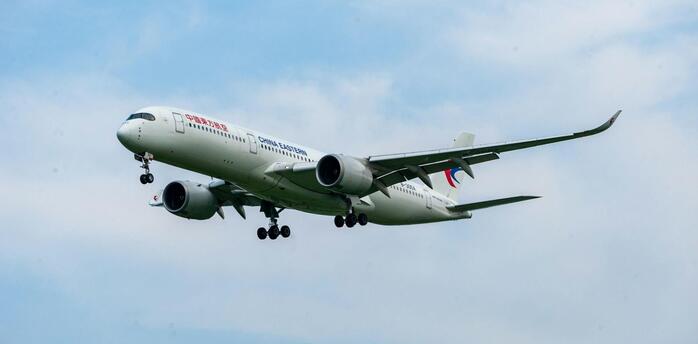 China Eastern Airlines aircraft approaching landing against a clear sky
