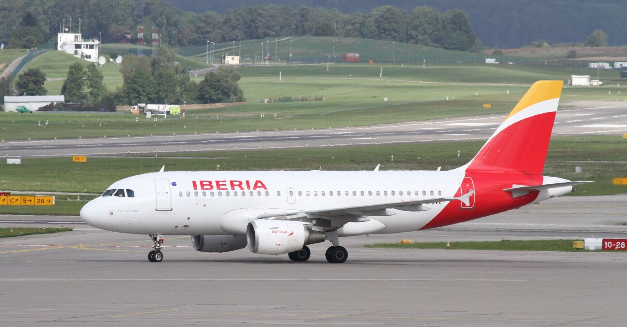 Iberia aircraft taxiing at an international airport