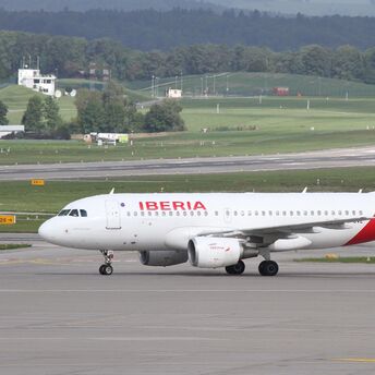 Iberia aircraft taxiing at an international airport