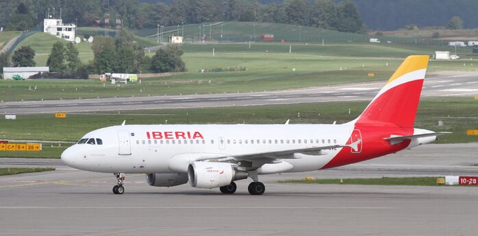 Iberia aircraft taxiing at an international airport