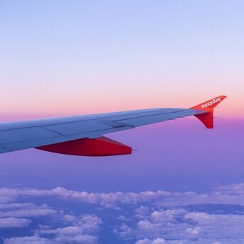 EasyJet wing above clouds during sunset