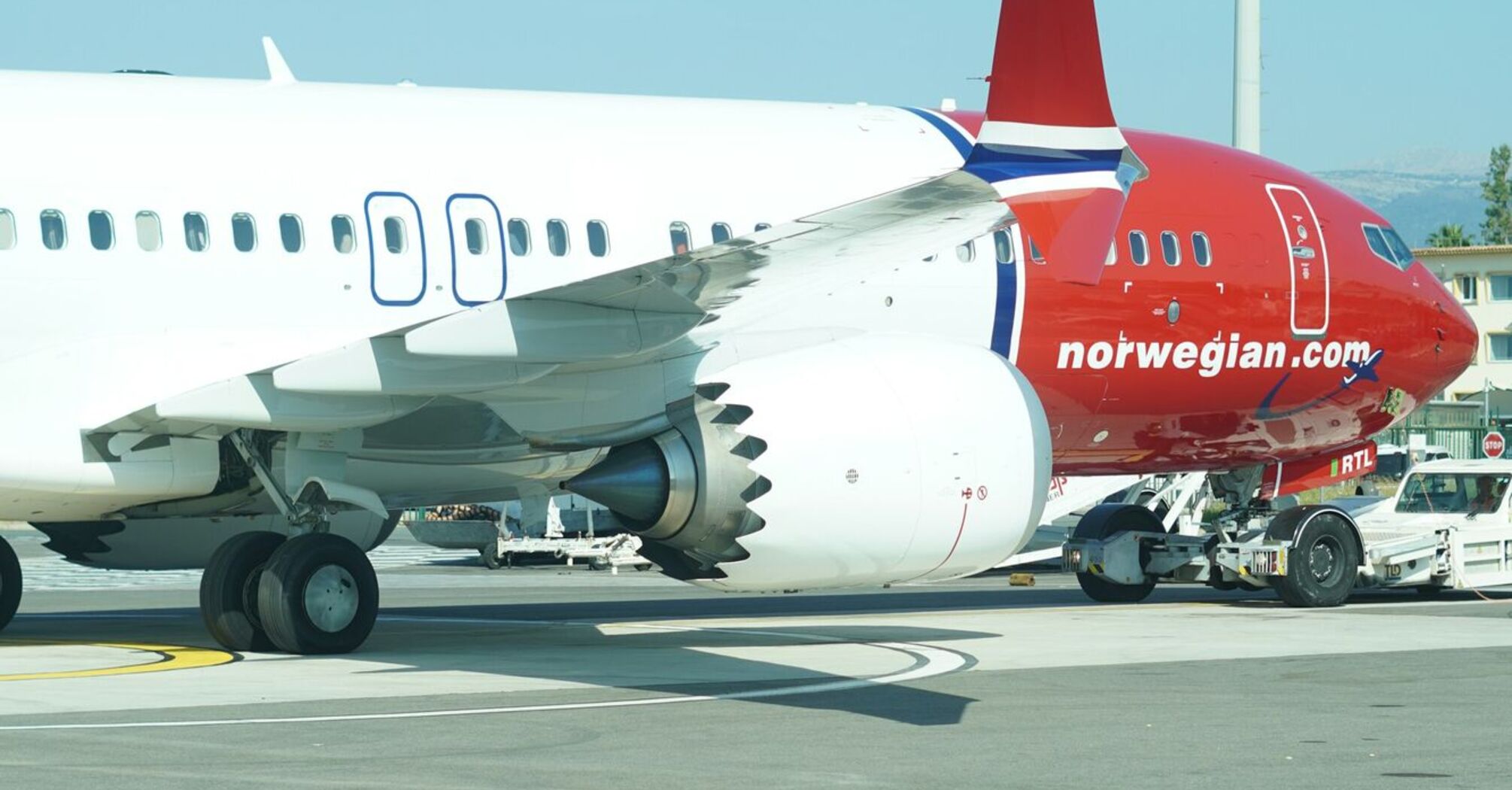 Norwegian aircraft parked on the tarmac during ground operations
