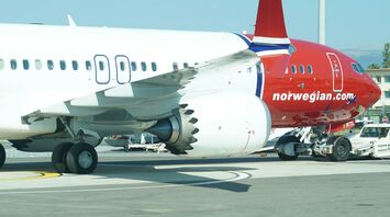 Norwegian aircraft parked on the tarmac during ground operations