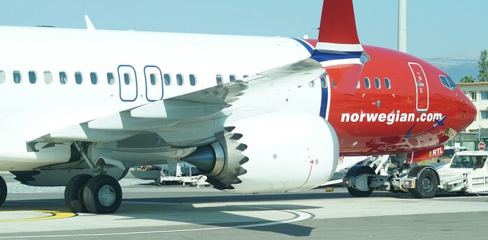 Norwegian aircraft parked on the tarmac during ground operations