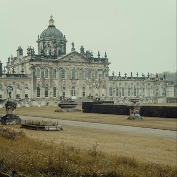 Historic British estate with a peacock in the foreground