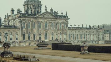 Historic British estate with a peacock in the foreground