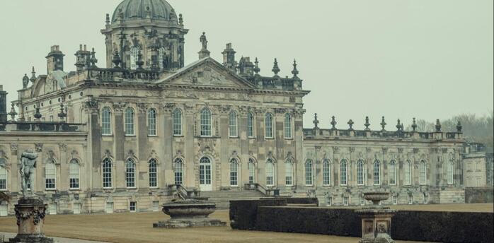 Historic British estate with a peacock in the foreground