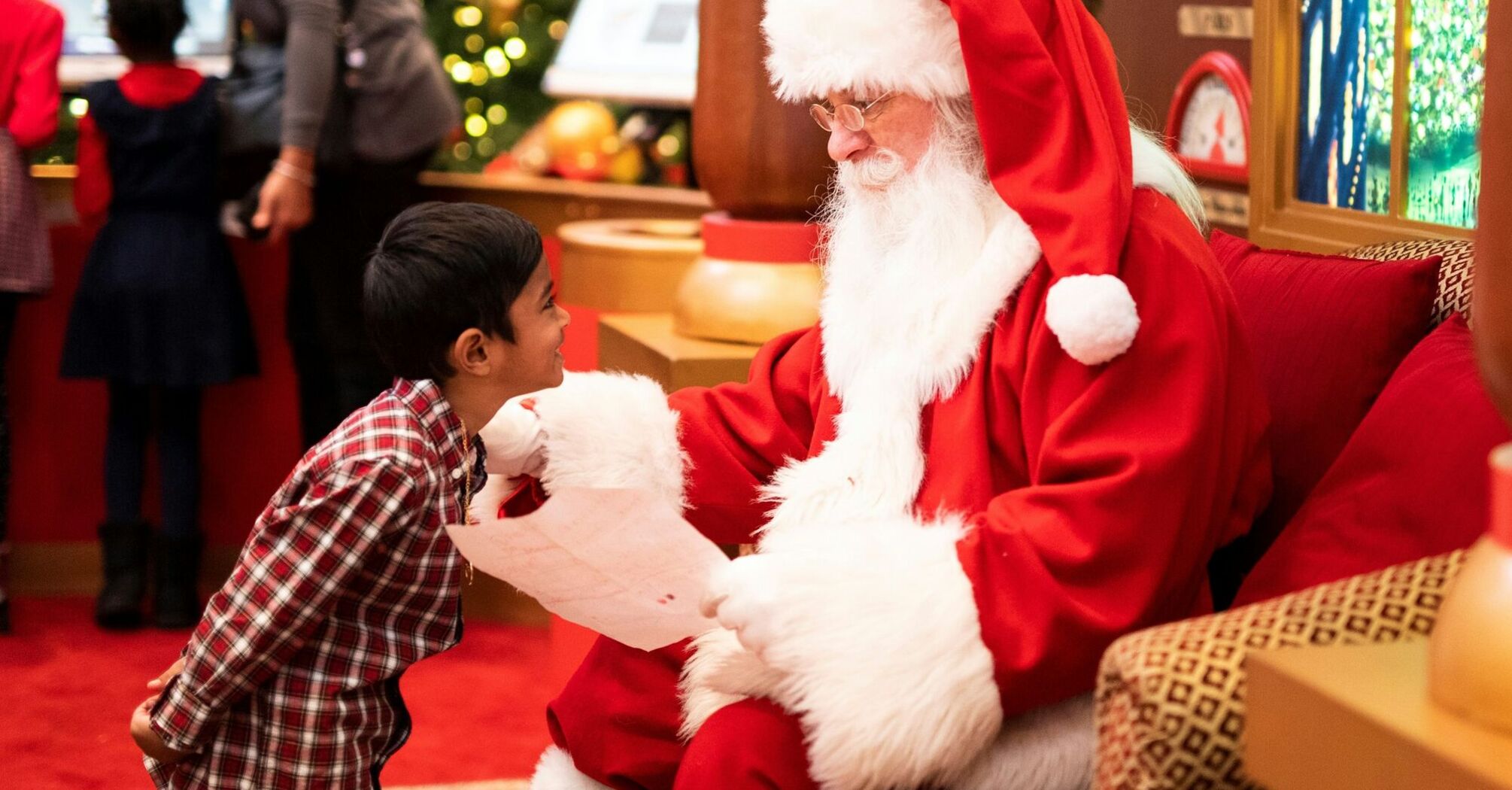 A child meeting Santa Claus during a festive visit
