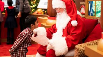 A child meeting Santa Claus during a festive visit