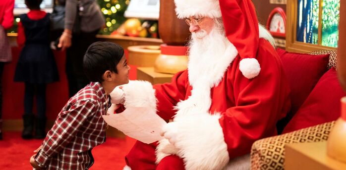 A child meeting Santa Claus during a festive visit