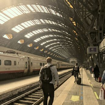 Passengers walking along a platform at Milan’s central station