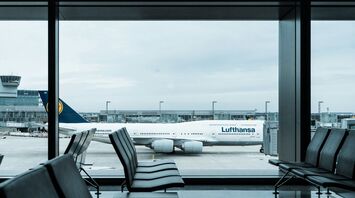 Lufthansa aircraft seen through airport terminal windows at Frankfurt