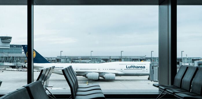 Lufthansa aircraft seen through airport terminal windows at Frankfurt