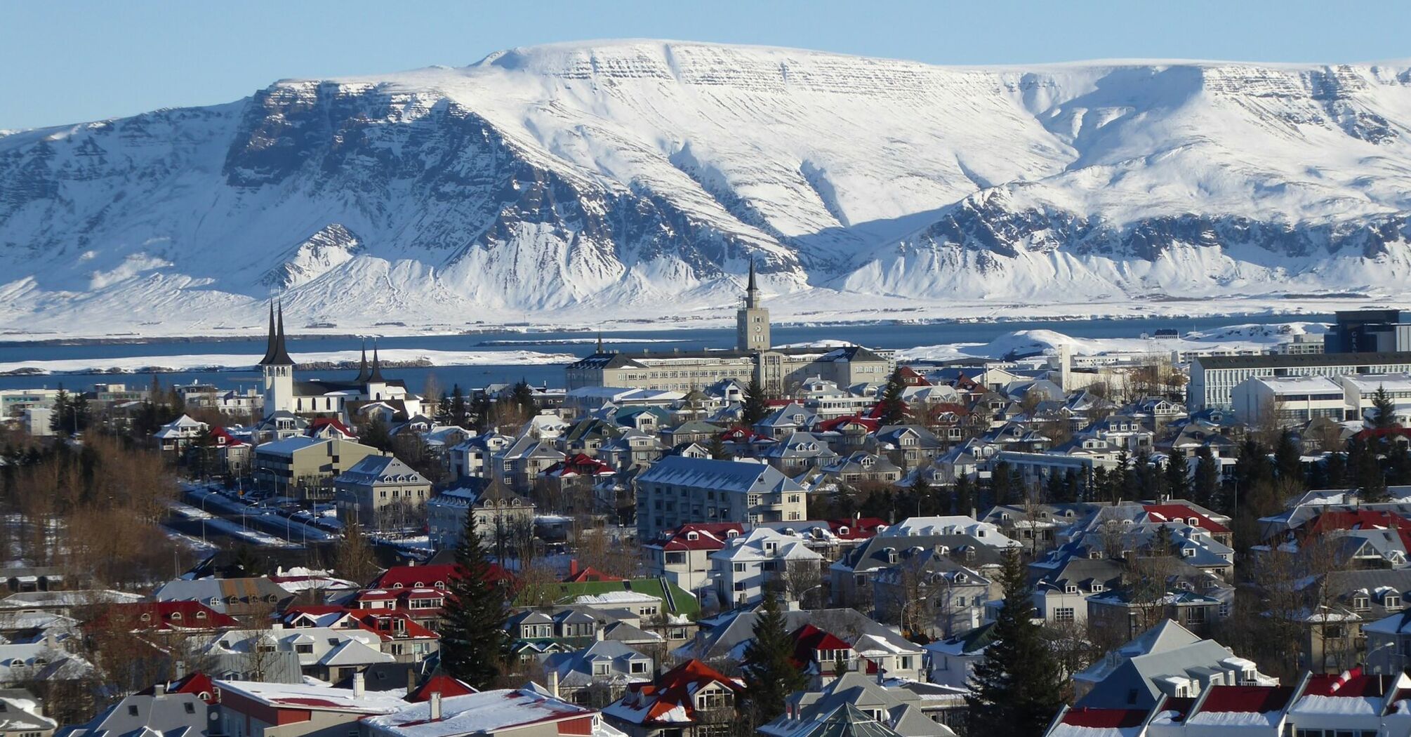 Reykjavík houses with snow-covered mountains in the background