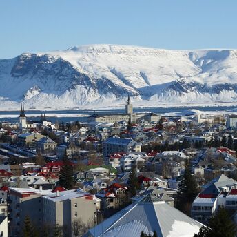 Reykjavík houses with snow-covered mountains in the background