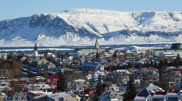 Reykjavík houses with snow-covered mountains in the background