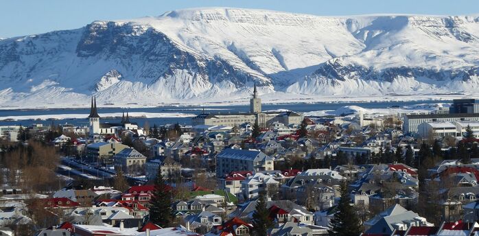 Reykjavík houses with snow-covered mountains in the background
