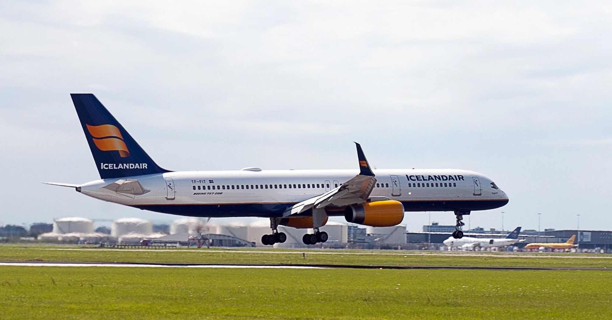 Icelandair aircraft taking off from a runway under cloudy skies