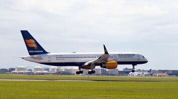 Icelandair aircraft taking off from a runway under cloudy skies