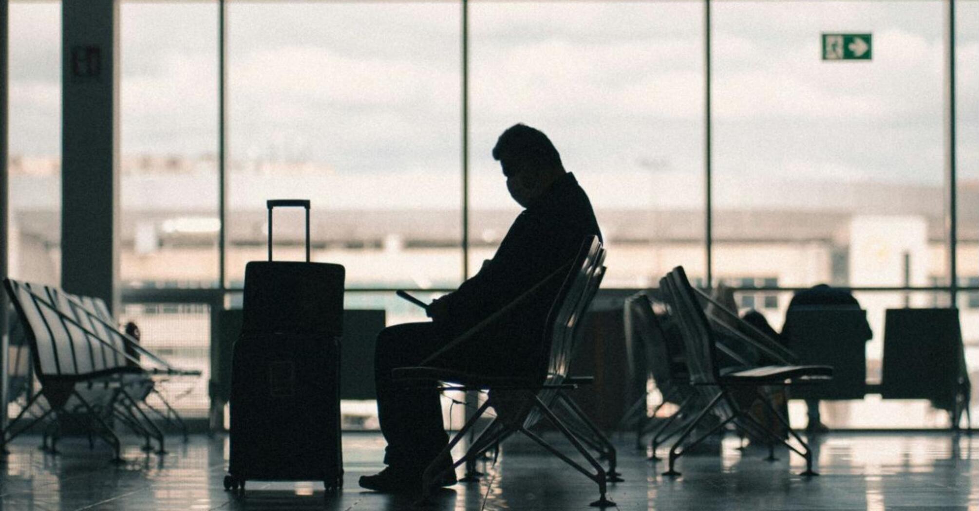 Passenger waiting in an airport terminal amid disruptions