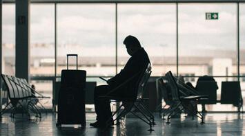 Passenger waiting in an airport terminal amid disruptions