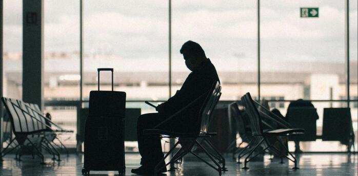 Passenger waiting in an airport terminal amid disruptions