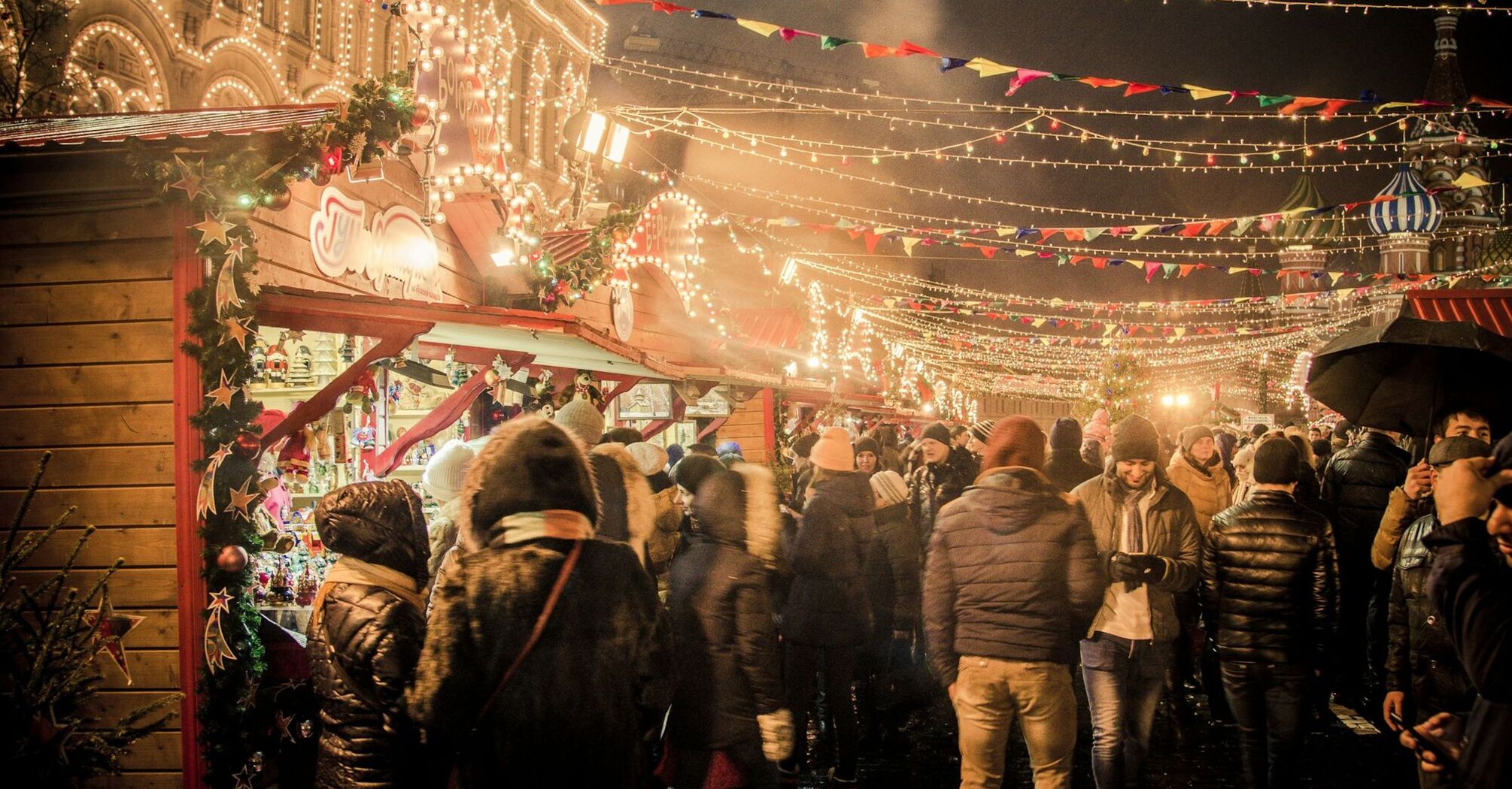 Crowds enjoy festive lights and stalls at a European Christmas market