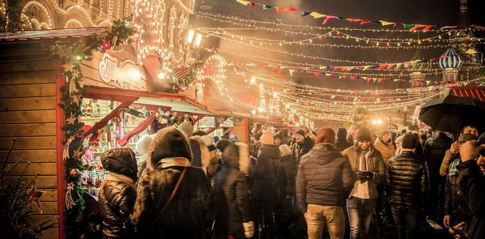 Crowds enjoy festive lights and stalls at a European Christmas market