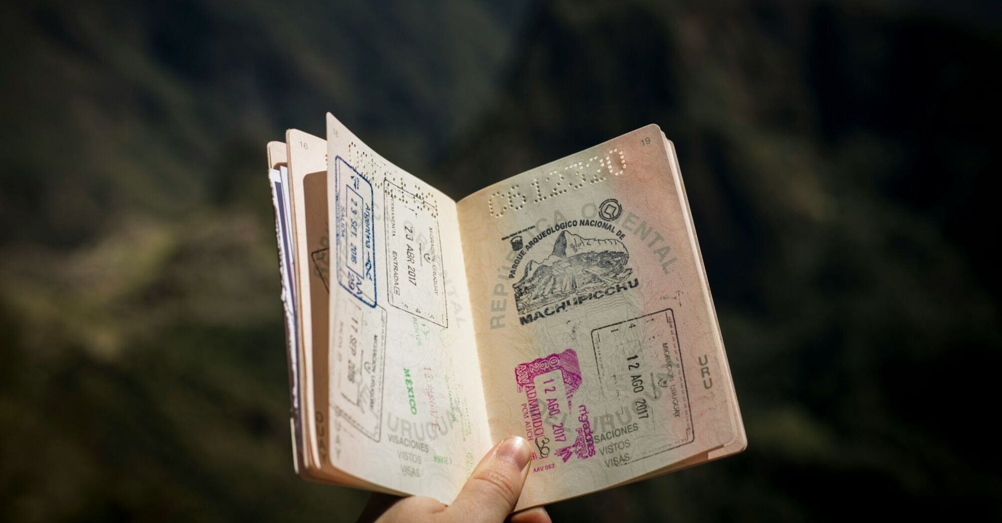 Open passport with multiple entry and exit stamps