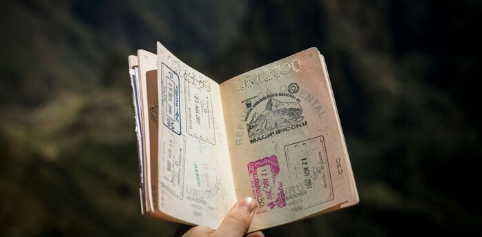Open passport with multiple entry and exit stamps