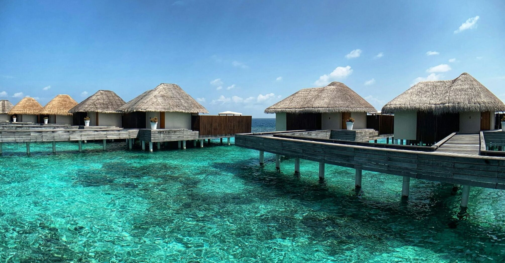 Overwater villas on a clear lagoon in the Maldives